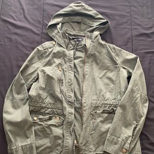 100% cotton, green jacket with hood and zipper.